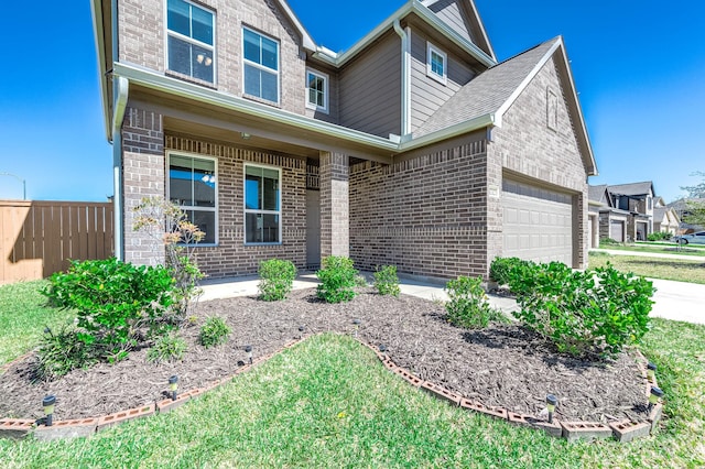 view of front of property featuring a garage, brick siding, and driveway