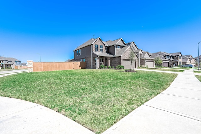 view of front of house featuring a residential view, brick siding, a front yard, and fence