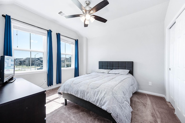 bedroom with light carpet, visible vents, baseboards, and lofted ceiling