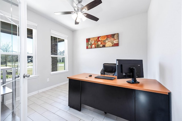 office featuring light tile patterned floors, baseboards, and ceiling fan