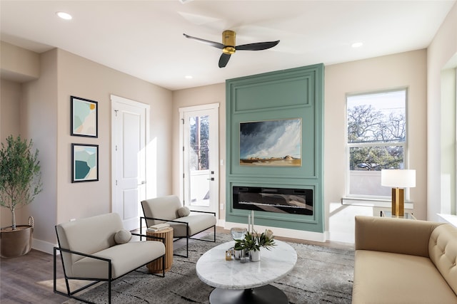 living room with recessed lighting, baseboards, wood finished floors, and a ceiling fan