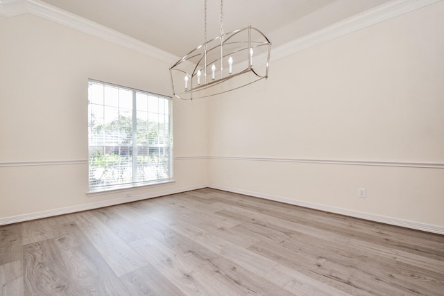 unfurnished dining area with baseboards, wood finished floors, a chandelier, and ornamental molding