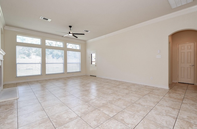 unfurnished room with visible vents, arched walkways, ceiling fan, and crown molding