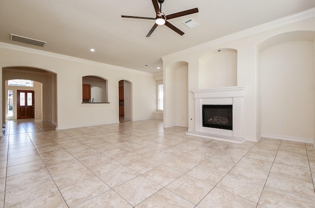 unfurnished living room featuring light tile patterned floors, a ceiling fan, visible vents, and a fireplace with raised hearth