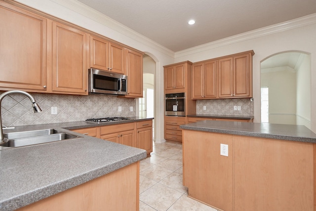 kitchen featuring ornamental molding, a sink, stainless steel appliances, arched walkways, and light tile patterned floors