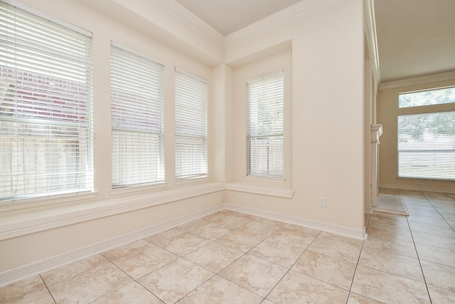 spare room with light tile patterned floors, baseboards, and ornamental molding