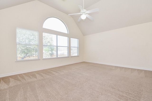 unfurnished room featuring baseboards, light carpet, high vaulted ceiling, and ceiling fan