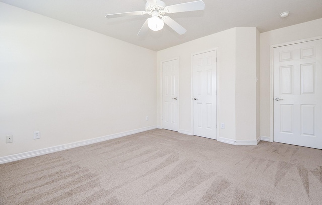 unfurnished bedroom with baseboards, carpet, and a ceiling fan