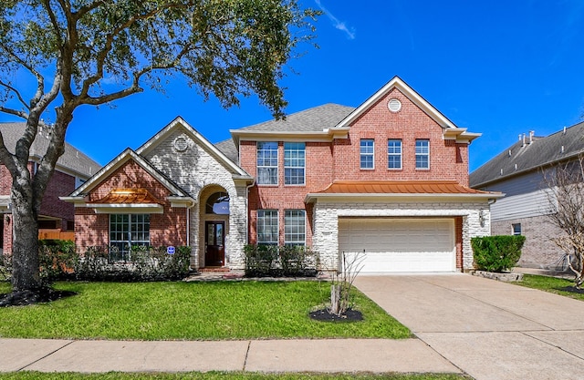 traditional-style home featuring an attached garage, concrete driveway, a standing seam roof, and a front yard