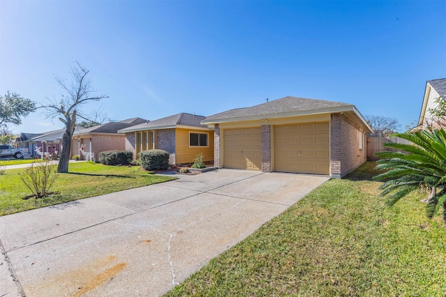 view of front of home with brick siding, fence, concrete driveway, a front yard, and a garage