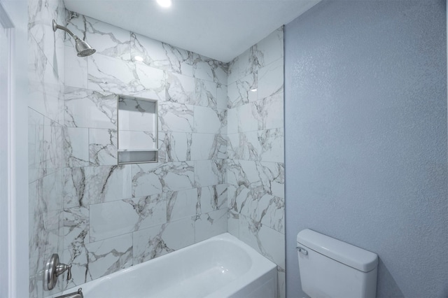 full bath with toilet,  shower combination, and a textured wall