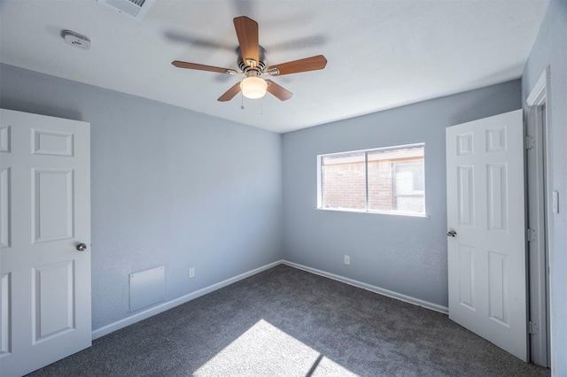 unfurnished bedroom featuring baseboards, visible vents, carpet floors, and ceiling fan