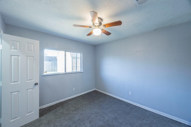 unfurnished room featuring a textured ceiling, baseboards, dark carpet, and ceiling fan