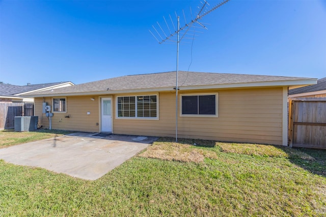 back of house featuring a patio, a lawn, central AC unit, and fence