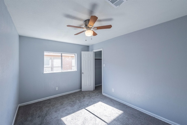 unfurnished bedroom featuring visible vents, baseboards, a ceiling fan, and carpet flooring