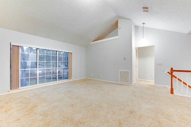 carpeted spare room featuring high vaulted ceiling, baseboards, visible vents, and a textured ceiling