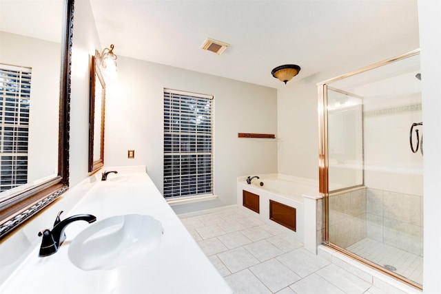 full bath with tile patterned flooring, a shower stall, a garden tub, and a sink