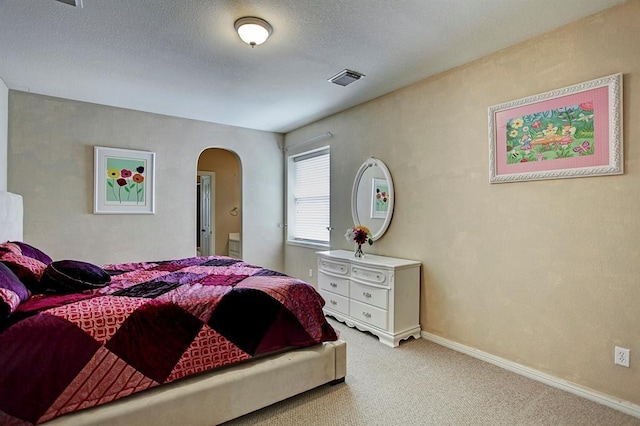 12610 Blanco Terrace Ln, Houston, TX 77041 - bedroom with arched walkways, carpet floors, baseboards, and a textured ceiling