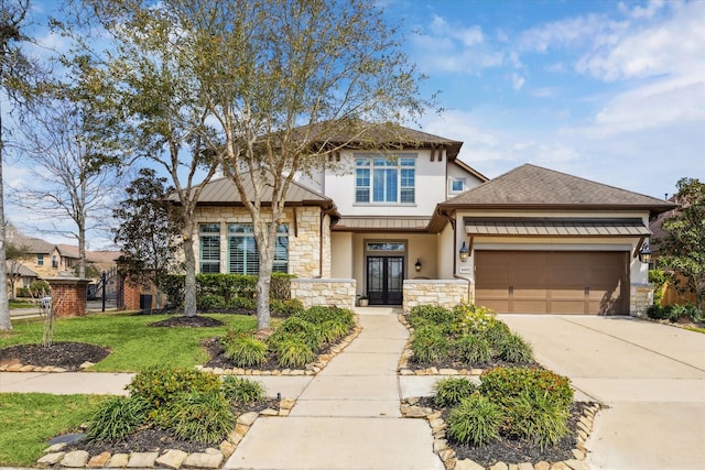 view of front of home with stucco siding, driveway, a front lawn, stone siding, and a garage