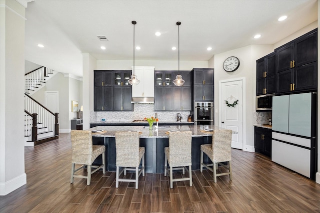 kitchen featuring glass insert cabinets, dark wood-style floors, visible vents, and appliances with stainless steel finishes