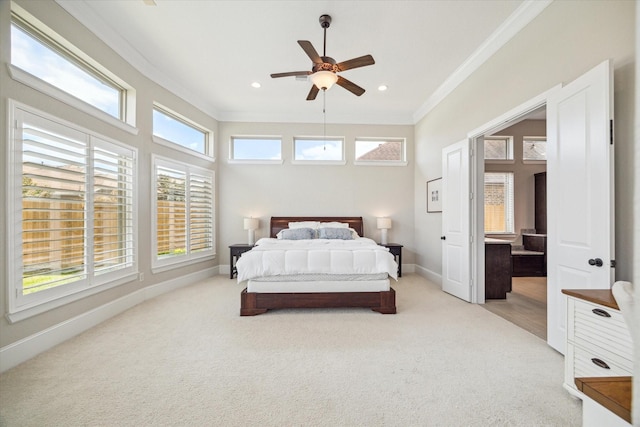 bedroom with baseboards, light colored carpet, and crown molding