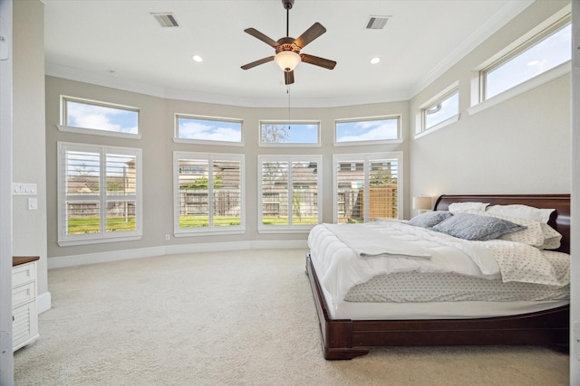 bedroom featuring visible vents, multiple windows, light colored carpet, and ornamental molding