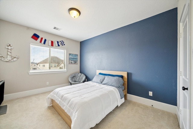 carpeted bedroom featuring visible vents and baseboards