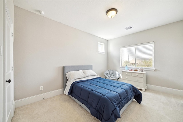 bedroom with visible vents, carpet flooring, and baseboards