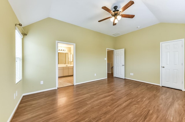 3034 Thicket Path Way, Katy, TX 77493 - unfurnished bedroom with vaulted ceiling, multiple windows, and wood finished floors