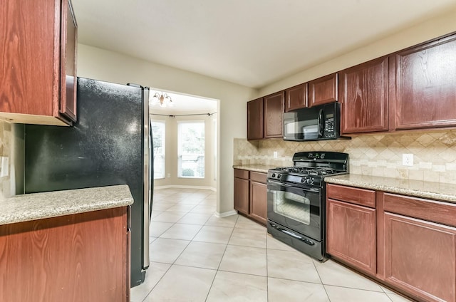3034 Thicket Path Way, Katy, TX 77493 - kitchen featuring backsplash, baseboards, light stone countertops, light tile patterned floors, and black appliances