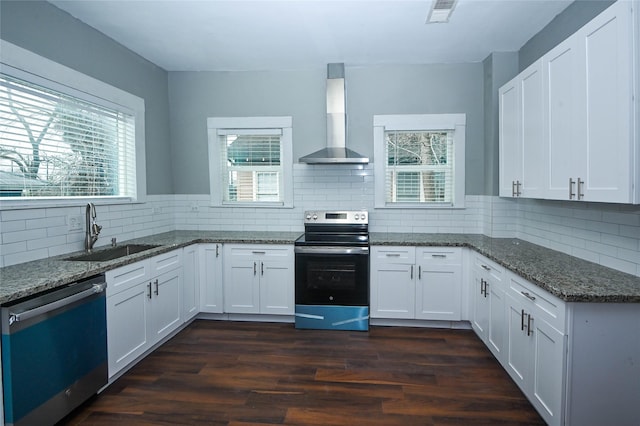 kitchen featuring dishwashing machine, visible vents, a sink, electric stove, and wall chimney exhaust hood