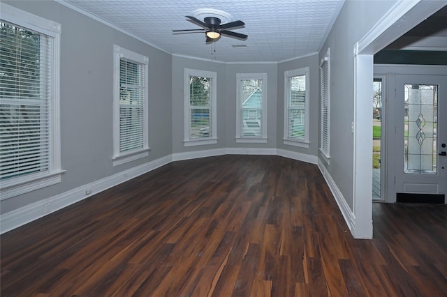 interior space with baseboards, crown molding, a ceiling fan, and wood finished floors