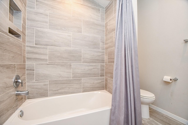 bathroom with shower / bath combination with curtain, toilet, and baseboards