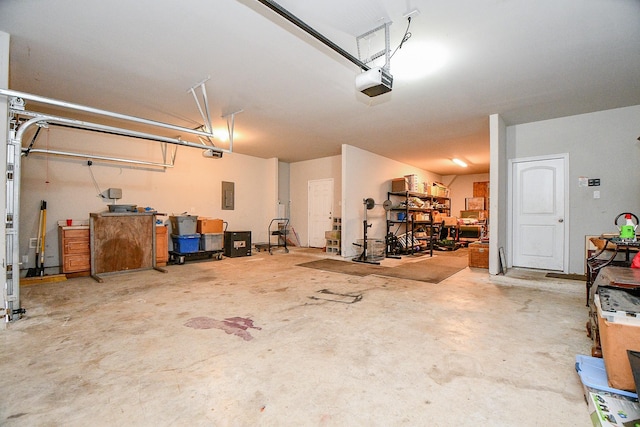 garage featuring electric panel and a garage door opener