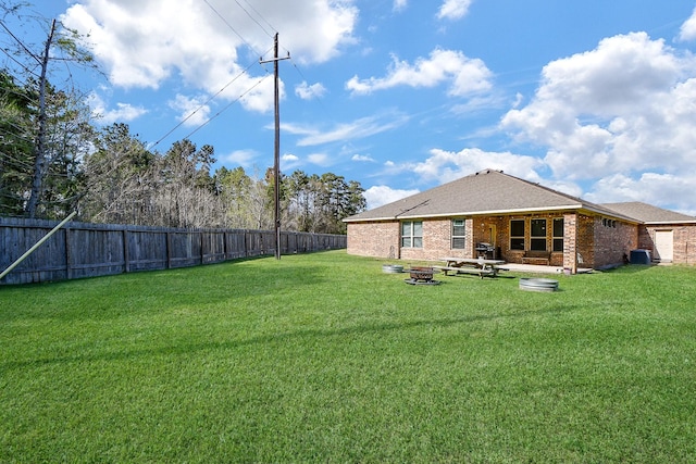 view of yard with an outdoor fire pit and a fenced backyard