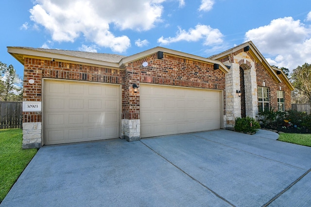 view of front of house featuring stone siding, brick siding, a garage, and driveway