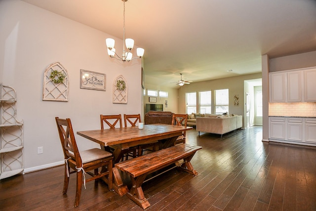 dining area featuring baseboards, dark wood-style floors, and ceiling fan with notable chandelier