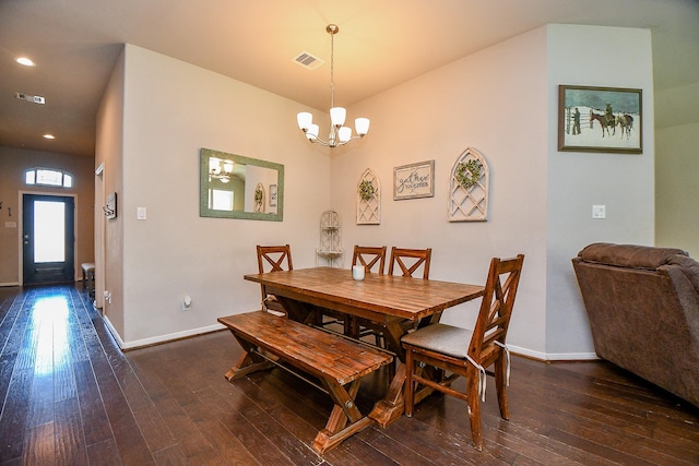 dining area with a chandelier, visible vents, baseboards, and hardwood / wood-style floors