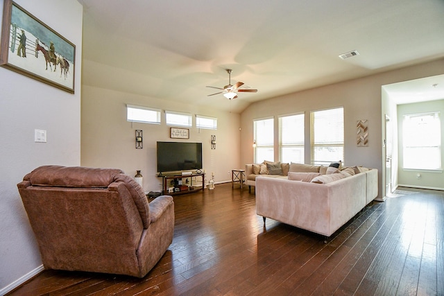 living area featuring visible vents, dark wood-type flooring, a ceiling fan, and vaulted ceiling