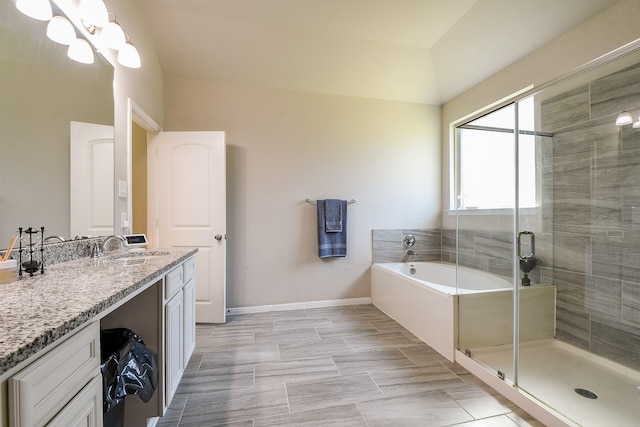 full bathroom featuring vanity, baseboards, an inviting chandelier, a stall shower, and a bath