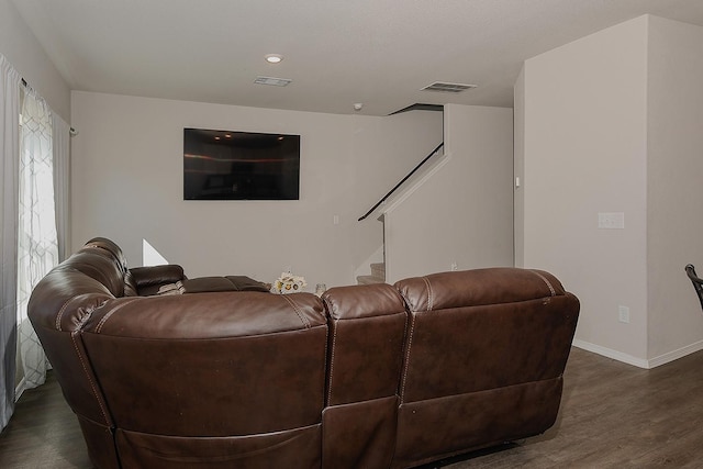 living area with visible vents, baseboards, stairs, and dark wood-type flooring