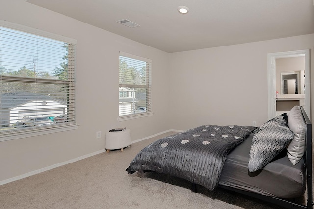 bedroom with carpet flooring, baseboards, and visible vents