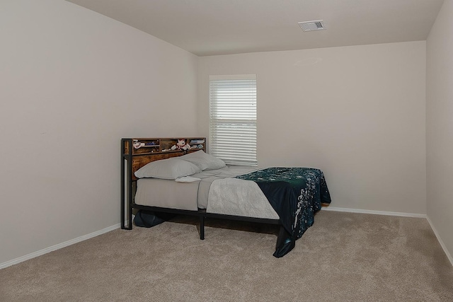 bedroom with visible vents, baseboards, and carpet flooring