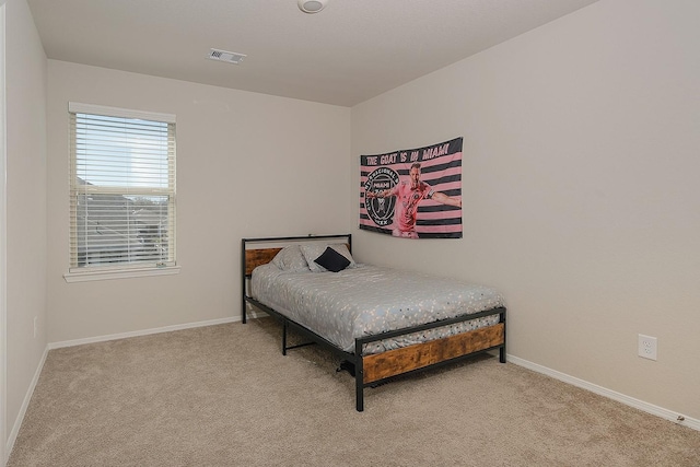 bedroom with visible vents, baseboards, and carpet