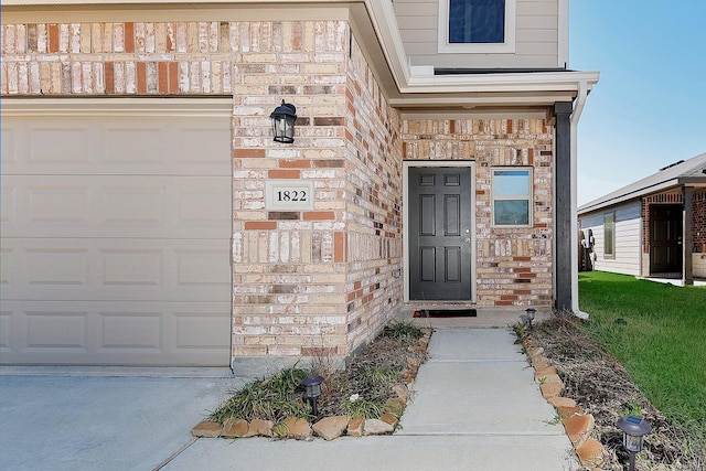 property entrance with brick siding, a garage, and stone siding