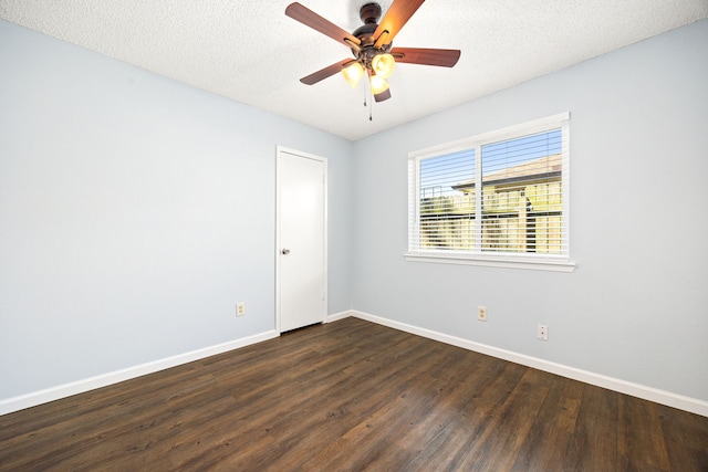 spare room featuring ceiling fan, baseboards, dark wood-style flooring, and a textured ceiling