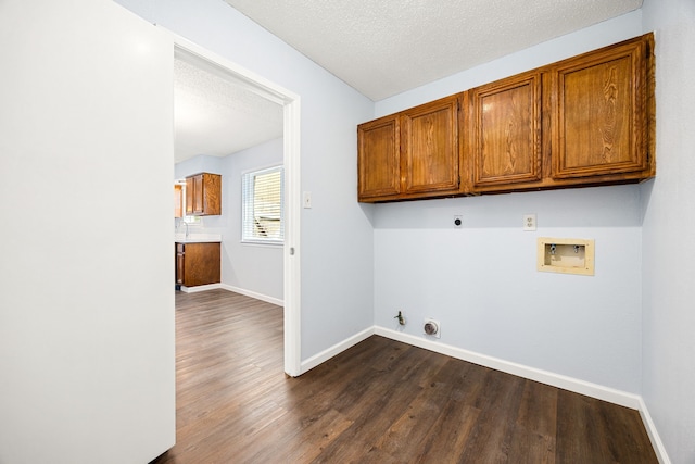 laundry room featuring baseboards, washer hookup, dark wood-style floors, cabinet space, and electric dryer hookup