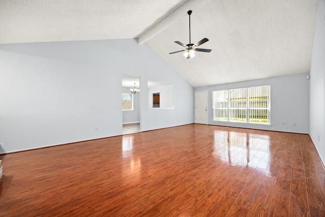 unfurnished living room with beamed ceiling, ceiling fan with notable chandelier, a textured ceiling, and wood finished floors