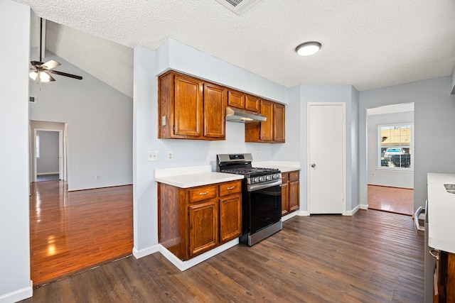 kitchen featuring a ceiling fan, under cabinet range hood, dark wood-style floors, gas stove, and light countertops