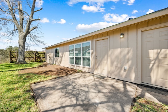 exterior space with a lawn, a patio, and fence